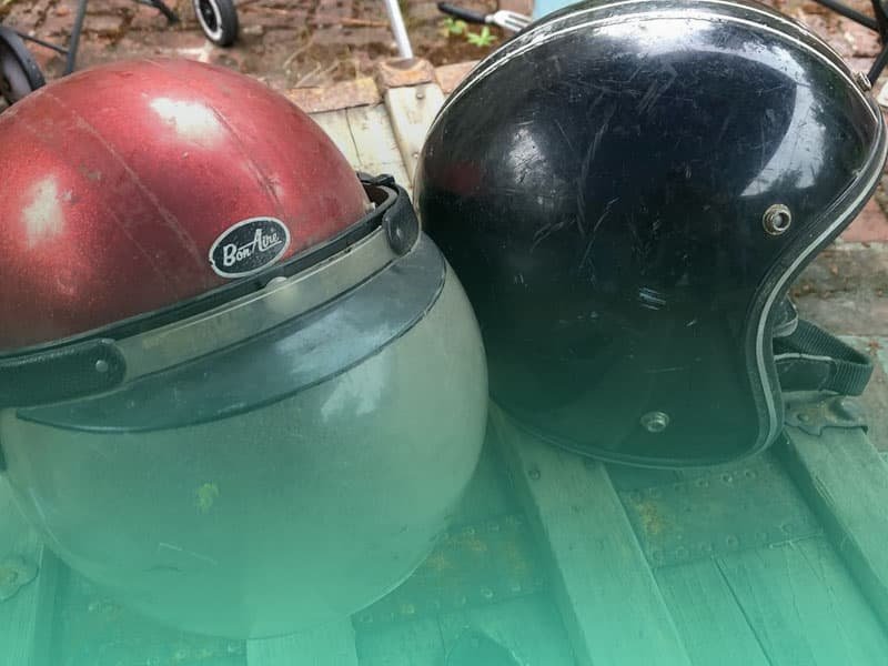 two old motorcycle helmets